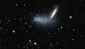 La galaxia enana irregular PGC 16389 cubre a la galaxia vecina APMBGC 252+125-117.