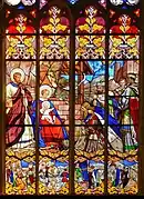 Vitral de la capilla que representa L'Adoration des mages así como las etapas precedentes y siguientes a su llegada a Belén (siglo XIX)
