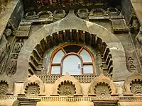 Exterior de la sala chaitya, cueva 9, Cuevas de Ajanta, siglo I a. C. El marco de la ventana en forma de arco chaitya se repite varias veces como motivo decorativo.