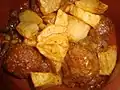 Albóndigas con salsa y patatas fritas, plato típico de España.