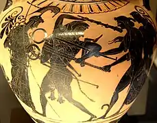 Ánfora de cerámica de figuras negras, que representa la disputa entre Apolo y Heracles por el trípode de Delfos. Relacionada con el denominado Grupo de Toronto 305. Hacia 510 a. C.