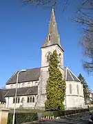 Christ Church (1861), Winchester, Hampshire, showing the south-east tower and broach spire and the polygonal chancel apse. The church has a striking clerestory with cinquefoil windows