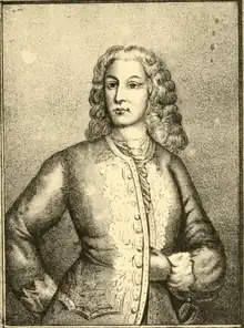 A bust-length portrait of a clean-shaven man with long hair
