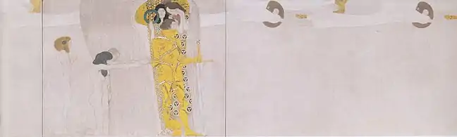 Muro izquierdo (continuación): Una niña de pie y una pareja arrodillada con las manos extendidas y suplicantes representan los sufrimientos de la Humanidad. La Humanidad sufriente implora al caballero dorado que emprenda por ellos la lucha por la felicidad. El caballero es apoyado por dos figuras femeninas, la Ambición (sosteniendo una corona de laurel) y la Compasión (entrelazando los manos), quienes son los impulsos internos que le mueven a luchar por conseguir la felicidad.
