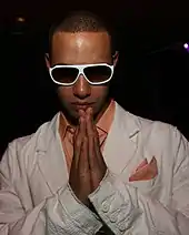 A picture of a bold man wearing sunglasses