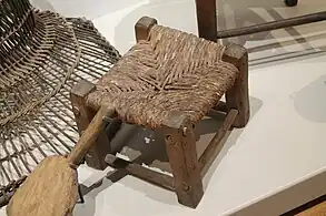 Escabel o taburete antiguo fabricado con madera y enea