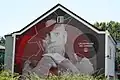 Mural  en una casa de la calle con la imagen de Celestino Lores, impulsor del Camino Portugués