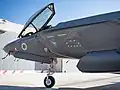An F-35I Adir of 117 Squadron "First Jet" (jet-in-the-crosshairs symbol) at the reopening in 2021