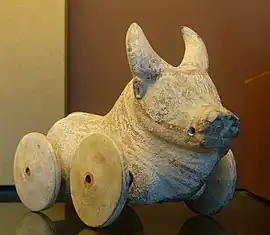 A buffalo figurine with wheels